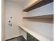 Clean laundry room with a countertop and floating shelves at 805 Wesley Oak Rd, Atlanta, GA 30328