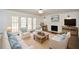 Inviting living room with fireplace, white furniture, and French doors at 805 Wesley Oak Rd, Atlanta, GA 30328