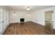 Spacious living room featuring a fireplace, hardwood floors, and French doors at 805 Wesley Oak Rd, Atlanta, GA 30328