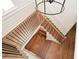Hardwood staircase with black metal railings and a modern chandelier for a bright and stylish look at 805 Wesley Oak Rd, Atlanta, GA 30328