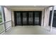 Covered balcony featuring french doors, ideal for enjoying outdoor views at 805 Wesley Oak Rd, Sandy Springs, GA 30328