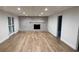 Finished basement features a modern brick fireplace, new floors, and white trim at 805 Wesley Oak Rd, Sandy Springs, GA 30328