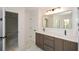 Bathroom featuring a double vanity with marble counters and updated fixtures at 805 Wesley Oak Rd, Sandy Springs, GA 30328
