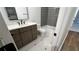 Modern bathroom with a hexagon tile floor, a gray tiled shower, and updated vanity at 805 Wesley Oak Rd, Sandy Springs, GA 30328