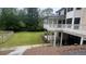 Covered deck with white railings, offering a shaded retreat and views of the serene backyard at 805 Wesley Oak Rd, Sandy Springs, GA 30328