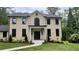 Elegant brick home featuring a stately front entrance with white columns and landscaped walkway at 805 Wesley Oak Rd, Sandy Springs, GA 30328