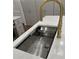 Close up of a kitchen island sink with a golden faucet and white marble counter top in neutral kitchen at 805 Wesley Oak Rd, Sandy Springs, GA 30328