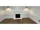 Bright living room featuring a classic fireplace, decorative molding, and beautiful hardwood floors at 805 Wesley Oak Rd, Sandy Springs, GA 30328