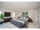 Comfortable main bedroom featuring a ceiling fan, TV, and a gray upholstered bed with blue accents at 805 Wesley Oak Rd, Sandy Springs, GA 30328