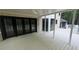 Spacious covered patio features brick accents, white pillars and a ceiling fan overlooking backyard at 805 Wesley Oak Rd, Sandy Springs, GA 30328