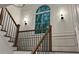 Close-up of staircase with dark railings and white accents with natural light at 805 Wesley Oak Rd, Sandy Springs, GA 30328
