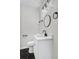 Modern bathroom features hexagon tile floor, white vanity, round mirror, and sleek black fixtures at 3393 Phillip Cir, Decatur, GA 30032