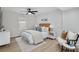 Bright bedroom featuring a ceiling fan, a window, a bed with stylish decor, and wood floors at 3393 Phillip Cir, Decatur, GA 30032