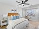Bright bedroom featuring a ceiling fan, a window, a bed with stylish decor, and wood floors at 3393 Phillip Cir, Decatur, GA 30032