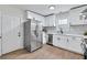 Well-equipped kitchen featuring white cabinets, stainless steel appliances, modern fixtures, and a functional layout at 3393 Phillips Cir, Decatur, GA 30032