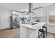 Modern kitchen featuring white cabinets, stainless steel appliances, a kitchen island, and stylish backsplash at 3393 Phillip Cir, Decatur, GA 30032