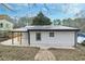 Newly renovated home featuring a metal roof, white siding and outdoor living space at 3393 Phillips Cir, Decatur, GA 30032