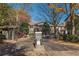 Gated community entrance with brick paved road surrounded by mature trees at 44 Finch Ne Trl, Atlanta, GA 30308