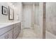 Modern bathroom showcasing dual sinks, gray cabinets, and a tiled shower with glass enclosure at 982 Harvest Park Ln, Suwanee, GA 30024