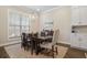 Dining area features a modern light fixture, large window, and comfortable seating for Gathering meals at 982 Harvest Park Ln, Suwanee, GA 30024