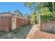 Brick home exterior showcasing the backyard, patio, and mature trees at 2837 Davidson Dr, Lithonia, GA 30058