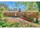 Brick home exterior showcasing the backyard, patio, and mature trees at 2837 Davidson Dr, Lithonia, GA 30058