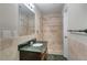 Bathroom with granite vanity, tiled shower, bronze fixtures, and decorative tile at 2837 Davidson Dr, Lithonia, GA 30058