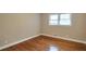 Bedroom featuring hardwood floors, neutral paint, window and white trim at 2837 Davidson Dr, Lithonia, GA 30058