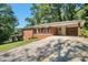 Well-kept brick home featuring a carport and a long, sloped driveway at 2837 Davidson Dr, Lithonia, GA 30058