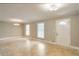 Bright living room features tile flooring, a modern light fixture, and a front door at 2837 Davidson Dr, Lithonia, GA 30058