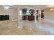 Open-concept living space with tile floors, fireplace, and kitchen view at 2837 Davidson Dr, Lithonia, GA 30058