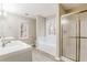 Bathroom featuring a double sink vanity, separate shower, bathtub, and large window at 145 Price Hills Ct, Sugar Hill, GA 30518