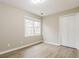 Cozy bedroom with a large window, closet, and light-colored wood-look flooring at 145 Price Hills Ct, Sugar Hill, GA 30518