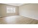 Spacious bedroom showcasing a large window, tray ceiling, and neutral color palette at 145 Price Hills Ct, Sugar Hill, GA 30518
