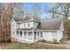 Two-story home showcasing the spacious layout, wraparound porch, and well-maintained exterior siding at 145 Price Hills Ct, Sugar Hill, GA 30518