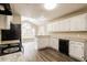 Bright kitchen with ample counter space, modern appliances, and a view into the breakfast nook at 145 Price Hills Ct, Sugar Hill, GA 30518