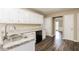Open concept kitchen featuring granite countertops, stainless sink, and contemporary cabinetry at 145 Price Hills Ct, Sugar Hill, GA 30518
