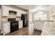 Well-equipped kitchen featuring modern appliances, granite countertops, and ample cabinet space at 145 Price Hills Ct, Sugar Hill, GA 30518