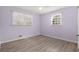 Bedroom showcasing two windows with blinds and luxury vinyl plank flooring at 146 Timberland St, Woodstock, GA 30188