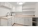 Kitchenette featuring white cabinets, appliances, and tiled floors at 146 Timberland St, Woodstock, GA 30188