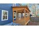 Outdoor covered back porch, wooden railing, ceiling fan and string lights at 1659 Olympian Sw Way, Atlanta, GA 30310