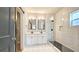Bathroom features a double vanity, modern fixtures, and a glass enclosed shower at 1659 Olympian Sw Way, Atlanta, GA 30310