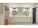 Modern bathroom with double vanity, stylish mirrors, and decorative tile flooring at 1659 Olympian Sw Way, Atlanta, GA 30310