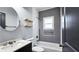 Well-lit bathroom with tiled shower, floating shelves, and modern fixtures at 1659 Olympian Sw Way, Atlanta, GA 30310