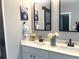 Modern bathroom with double vanity, quartz countertops, and framed mirrors at 1659 Olympian Sw Way, Atlanta, GA 30310