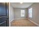 Bright bedroom with two windows, neutral carpeting, and minimalist design at 1659 Olympian Sw Way, Atlanta, GA 30310
