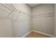 Empty walk-in closet featuring metal racks and neutral carpeting at 1659 Olympian Sw Way, Atlanta, GA 30310