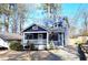 Inviting two-story home with a classic blue exterior, white trim, and a cozy front porch at 1659 Olympian Sw Way, Atlanta, GA 30310