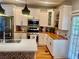 Updated kitchen with white cabinets, stainless steel appliances, and contrasting butcher block countertops at 1659 Olympian Sw Way, Atlanta, GA 30310