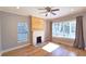 Cozy living room with a brick fireplace, hardwood floors, and lots of natural light at 1659 Olympian Sw Way, Atlanta, GA 30310